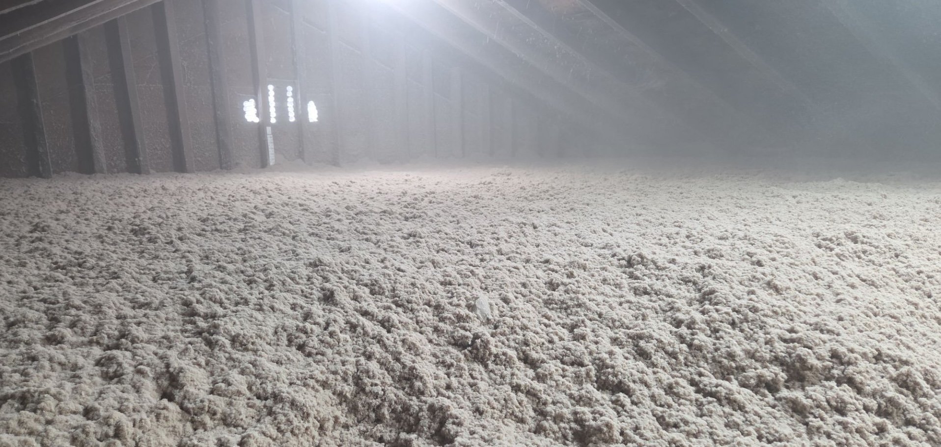 An attic filled with insulation.
